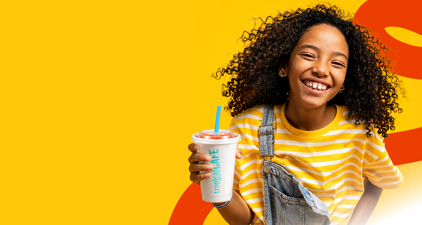 No Kid Hungry promotional banner showcasing a kid holding a Tropical Smoothie Cafe smoothie cup with a yellow background and tagline “filling bellies, fighting hunger”